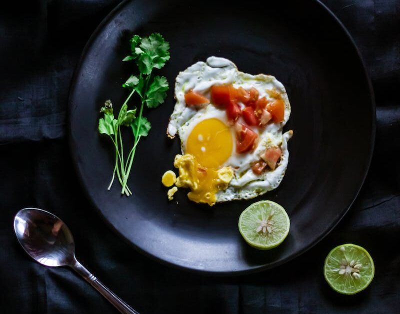 Overhead Shot of a Sunny Side up Egg with Chopped Tomatoes