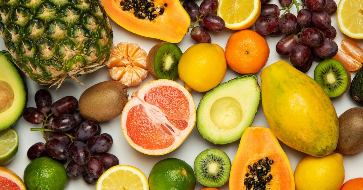 sliced orange fruit and green round fruits